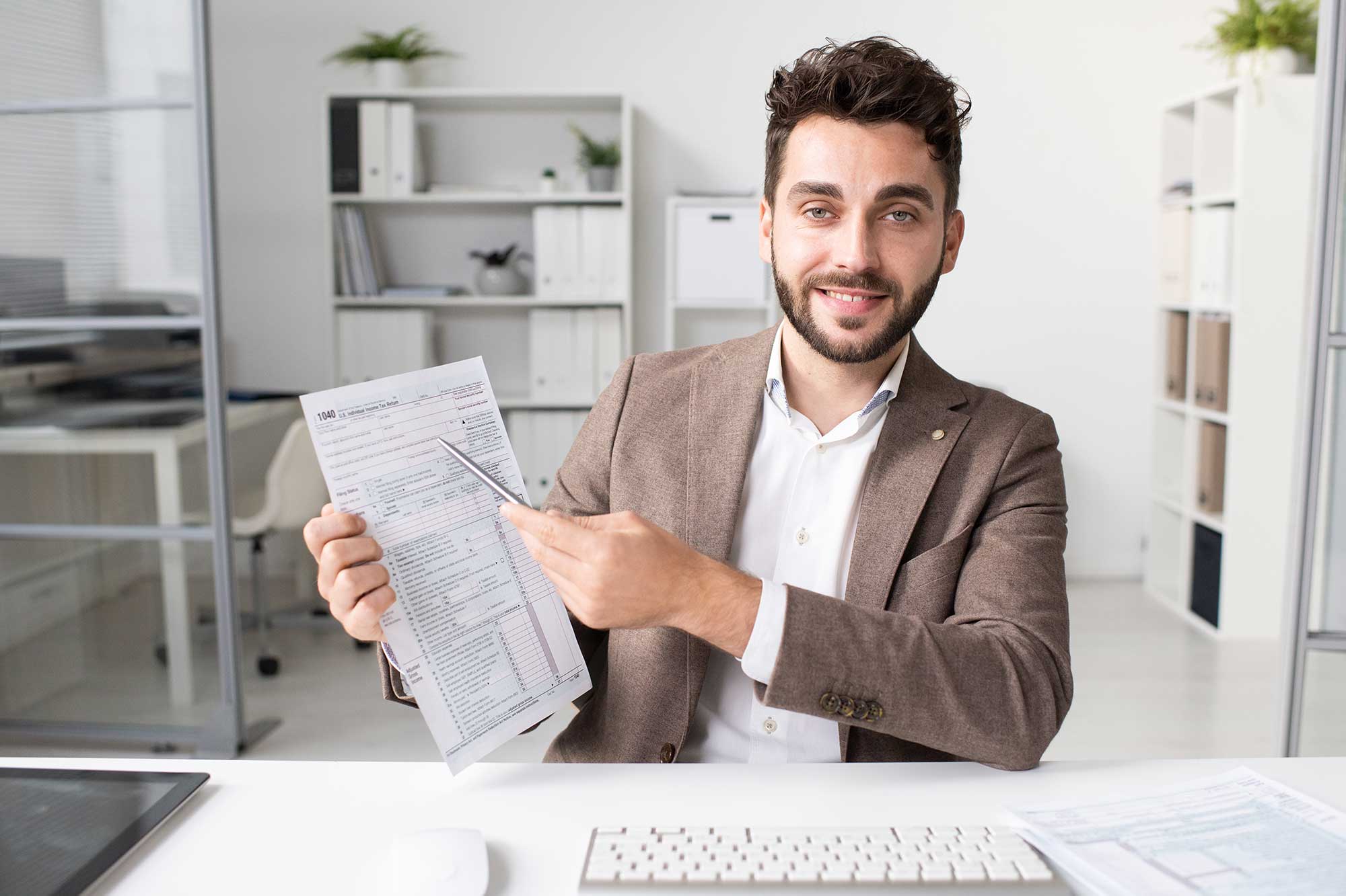 accountant-pointing-at-tax-form-2023-11-27-04-51-47-utc.jpg